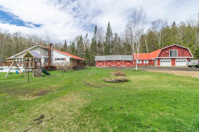 7206 S Wheelock Rd, Wheelock, VT 05851 - view of green lawn featuring a playground, a garage, and driveway