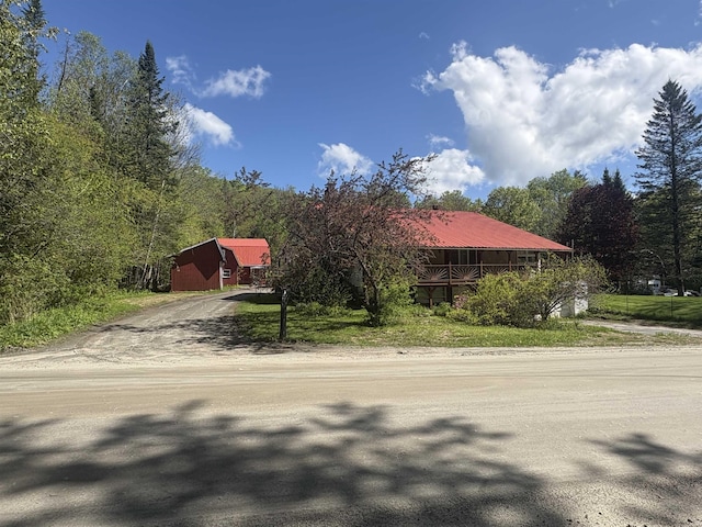 7206 S Wheelock Rd, Wheelock, VT 05851 - view of front of house with driveway and a wooded view