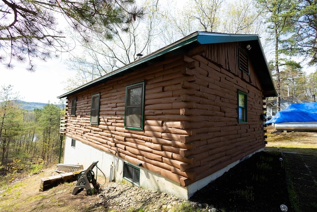 view of property exterior featuring log exterior