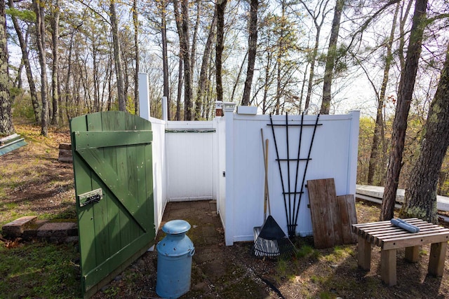 view of outdoor structure featuring a gate and fence