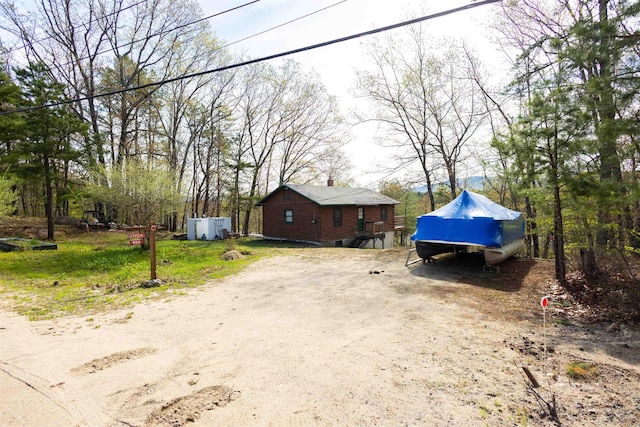 view of property exterior with a chimney
