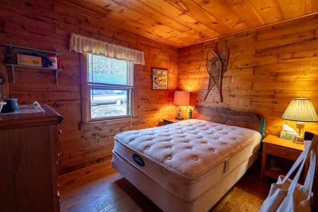 bedroom featuring wood-type flooring, wood walls, and wooden ceiling