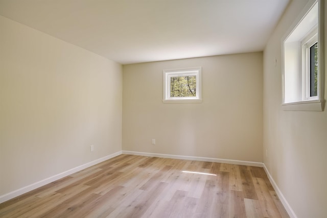 unfurnished room featuring light wood-style floors and baseboards