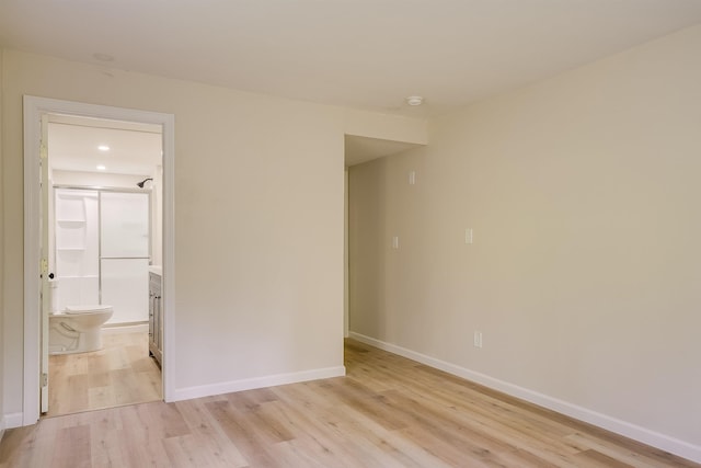 unfurnished room with light wood finished floors, baseboards, and recessed lighting