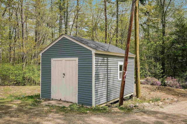 view of shed with a forest view