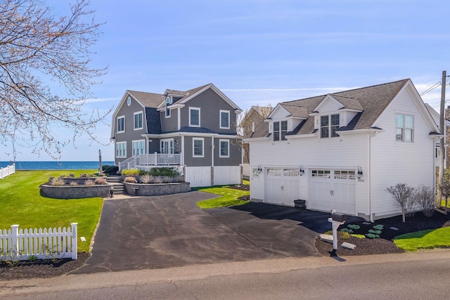 150 Webhannet Dr, Wells, ME 04090 - view of front of property with asphalt driveway, a garage, fence, and roof with shingles