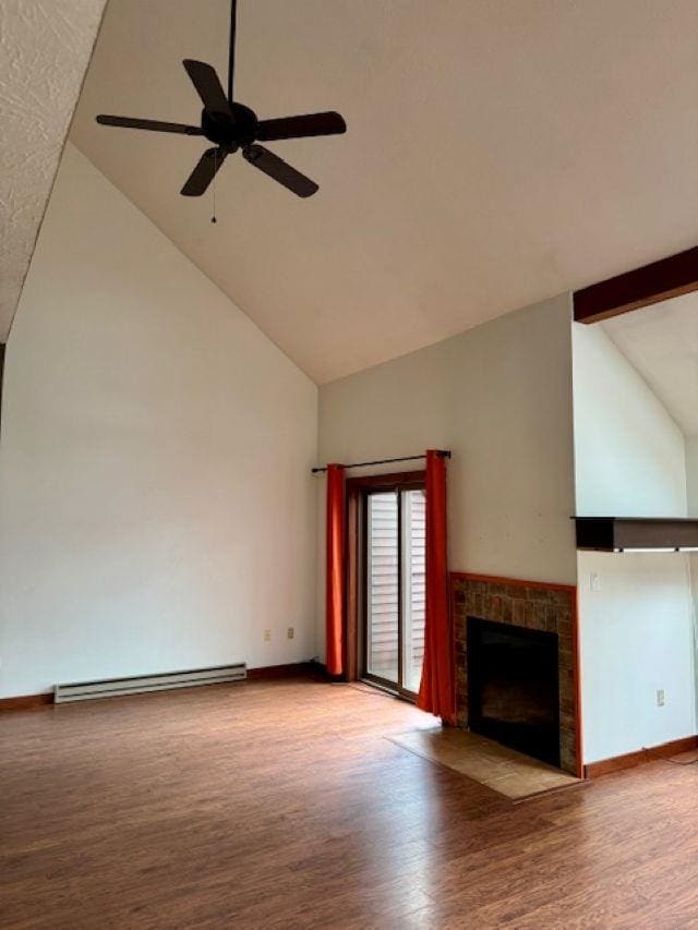 27 Mountainside Ln Unit 5, Francestown, NH 03043 - unfurnished living room with high vaulted ceiling, a fireplace with flush hearth, wood finished floors, a ceiling fan, and a baseboard heating unit
