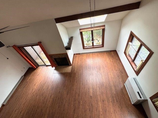 27 Mountainside Ln Unit 5, Francestown, NH 03043 - unfurnished living room featuring wood finished floors, healthy amount of natural light, a fireplace, and vaulted ceiling