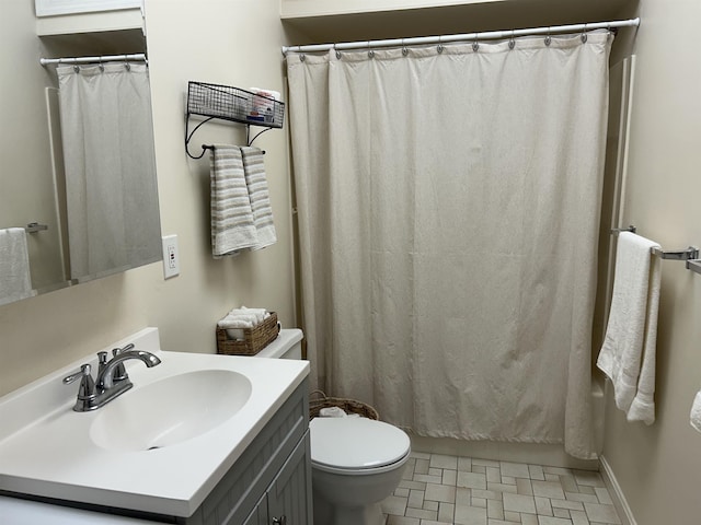 bathroom featuring toilet and vanity