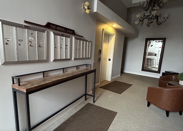 foyer entrance with carpet flooring, a chandelier, and baseboards