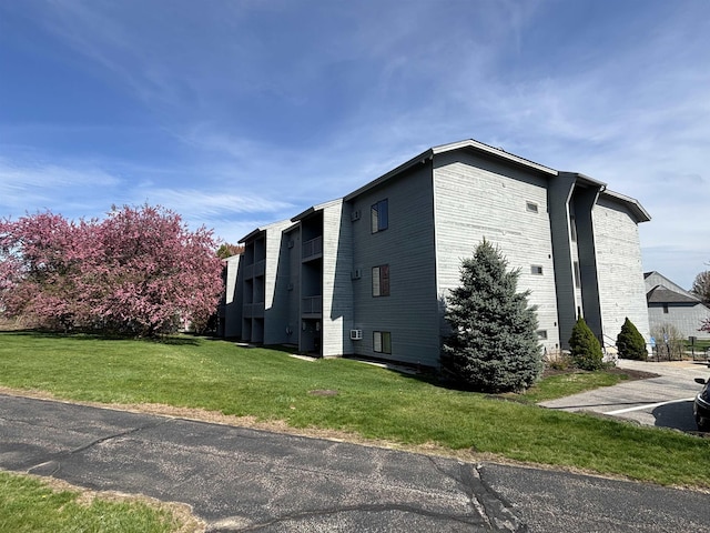5 Tsienneto Rd Unit 186, Derry, NH 03038 - view of home's exterior featuring a lawn and brick siding