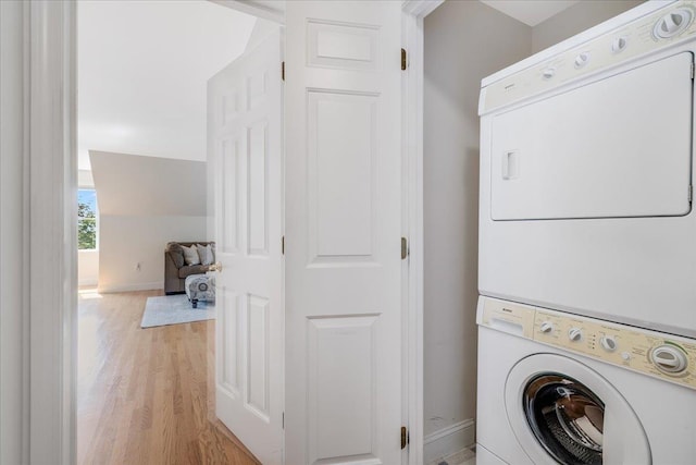 371 Tibbetts Hill Rd, Goffstown, NH 03045 - washroom featuring estacked washer and dryer and light wood-type flooring