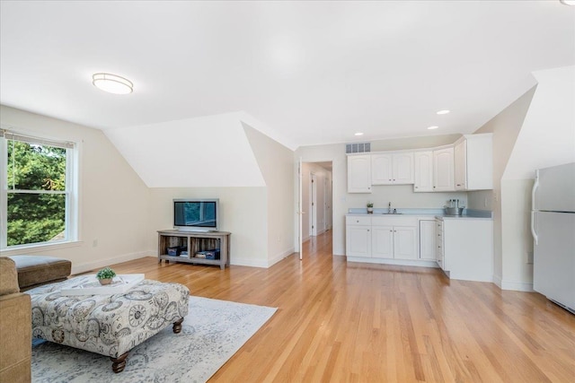 371 Tibbetts Hill Rd, Goffstown, NH 03045 - living room with light wood finished floors, lofted ceiling, and recessed lighting