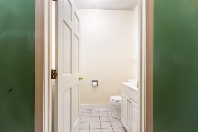 bathroom with tile patterned flooring, toilet, and vanity