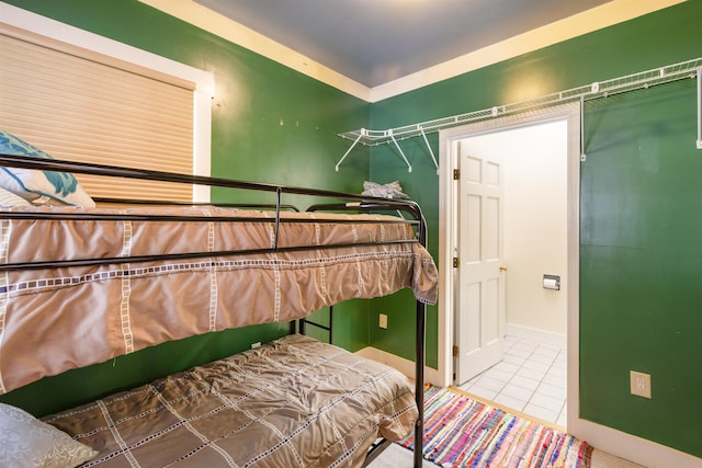 bedroom featuring baseboards and tile patterned flooring