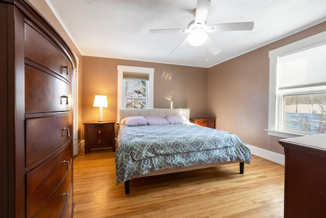 bedroom with light wood-type flooring, baseboards, and ceiling fan