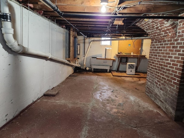 basement featuring a workshop area and electric panel