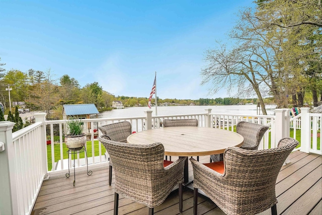 wooden deck featuring a water view and outdoor dining space