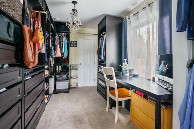 walk in closet with carpet floors and a chandelier