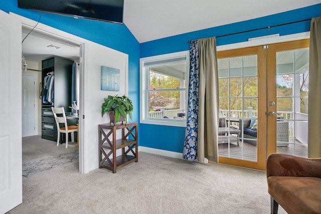 living area featuring vaulted ceiling, carpet flooring, french doors, and baseboards