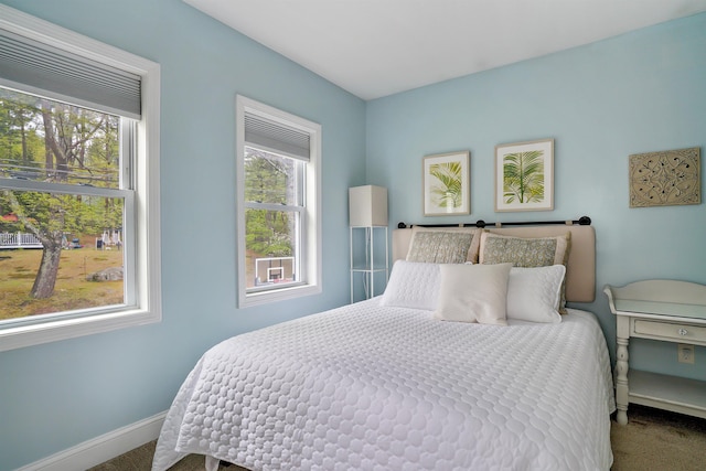 carpeted bedroom featuring baseboards