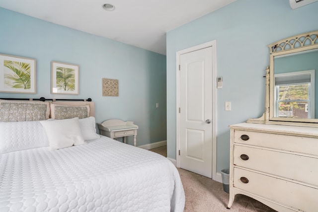 bedroom featuring light carpet and baseboards