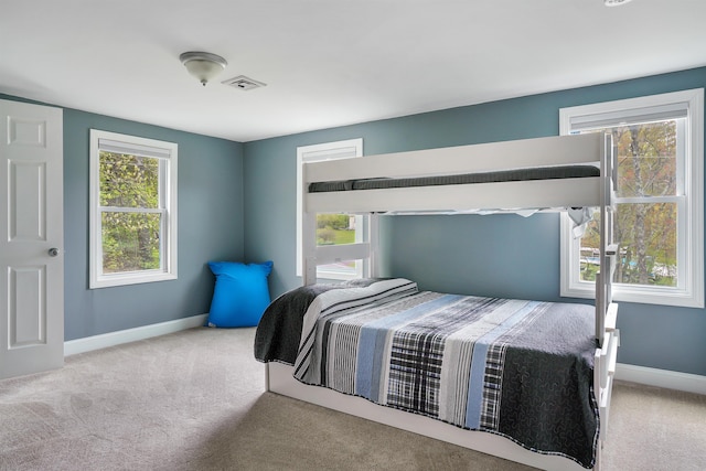 carpeted bedroom featuring baseboards