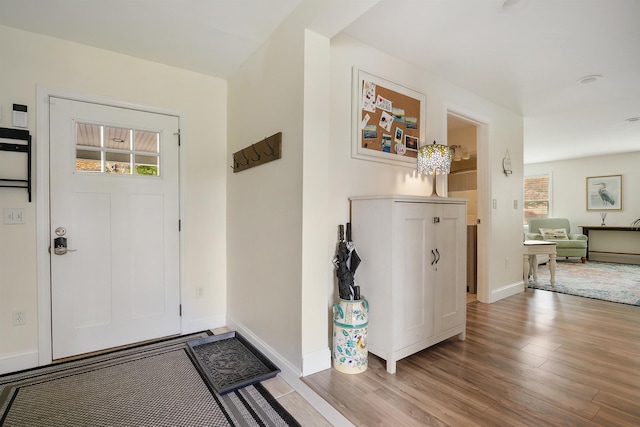entrance foyer with wood finished floors and baseboards