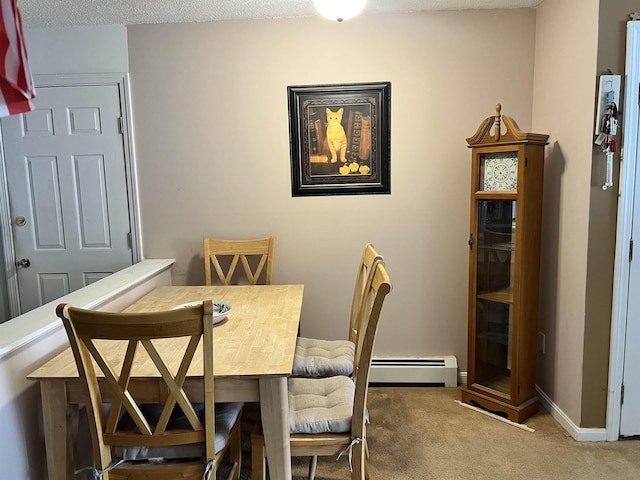 carpeted dining area featuring a baseboard heating unit and baseboards