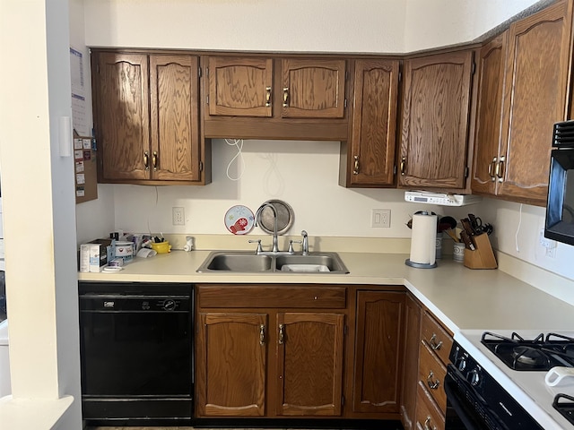 kitchen featuring black appliances, a sink, and light countertops