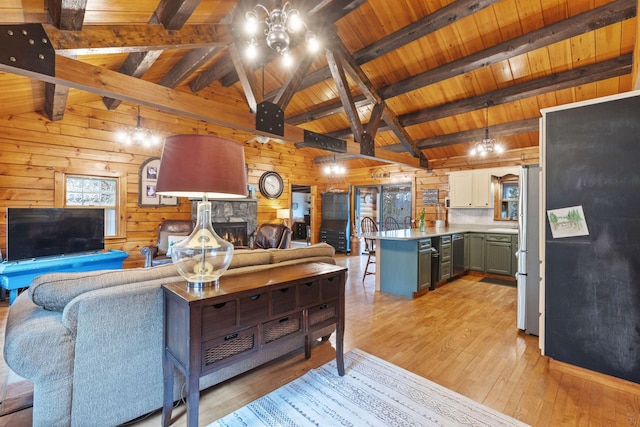 living room with wood walls, light wood-style floors, a stone fireplace, wood ceiling, and wine cooler