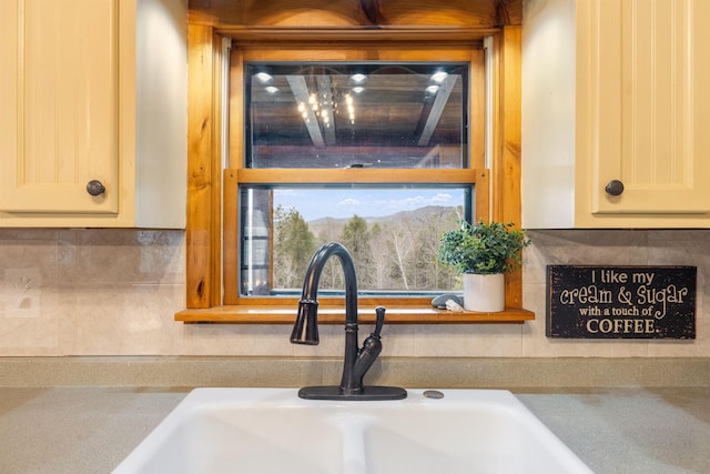 kitchen view of a sink and tasteful backsplash