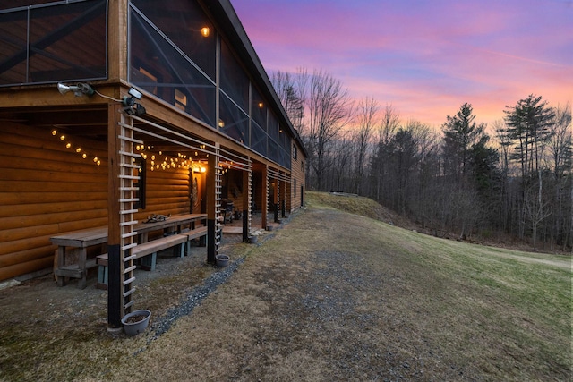 view of side of home featuring an outbuilding and an exterior structure