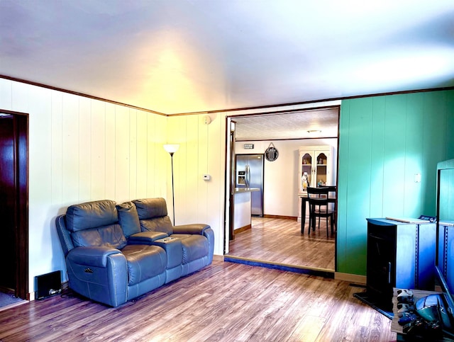 living room featuring wood finished floors and baseboards