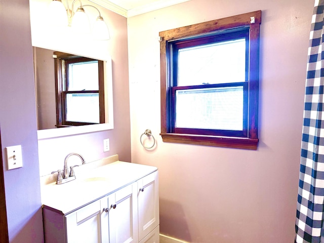 full bath featuring plenty of natural light, vanity, baseboards, and ornamental molding