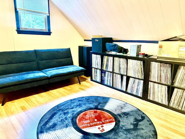 living room with wood finished floors and lofted ceiling