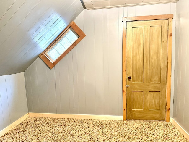 additional living space with lofted ceiling, carpet flooring, and baseboards