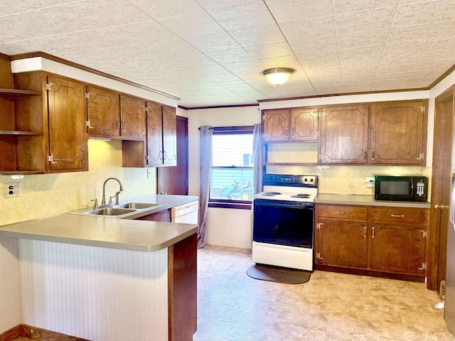 kitchen featuring range with electric stovetop, black microwave, open shelves, a peninsula, and a sink