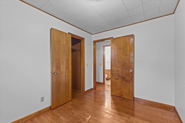 173 Tracy Dr, Burlington, VT 05408 - unfurnished bedroom with crown molding, wood finished floors, baseboards, and a closet