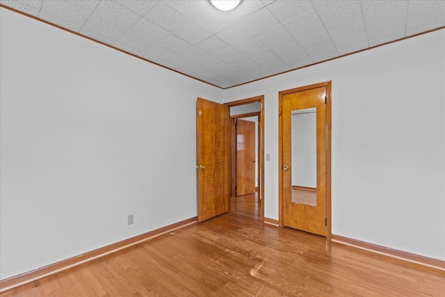 173 Tracy Dr, Burlington, VT 05408 - empty room featuring wood finished floors, baseboards, and crown molding