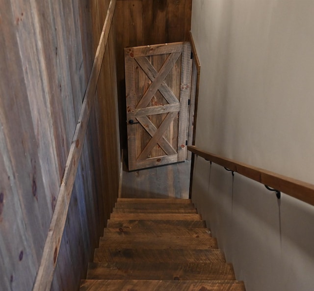 stairs featuring wooden walls