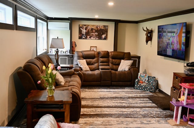 living room with a wall unit AC, ornamental molding, recessed lighting, and wood finished floors