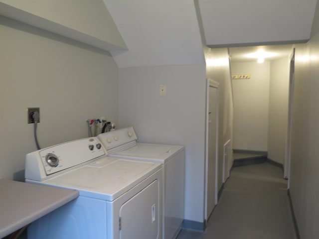 washroom featuring washer and clothes dryer and baseboards