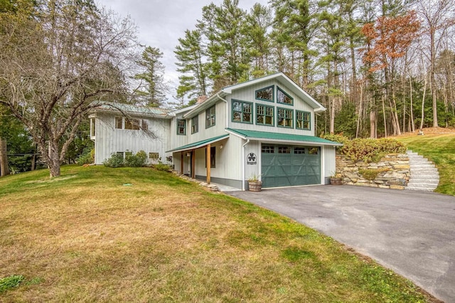 406 Partridge Lake Rd, Littleton, NH 03561 - view of front of home with asphalt driveway, an attached garage, a front yard, and a chimney