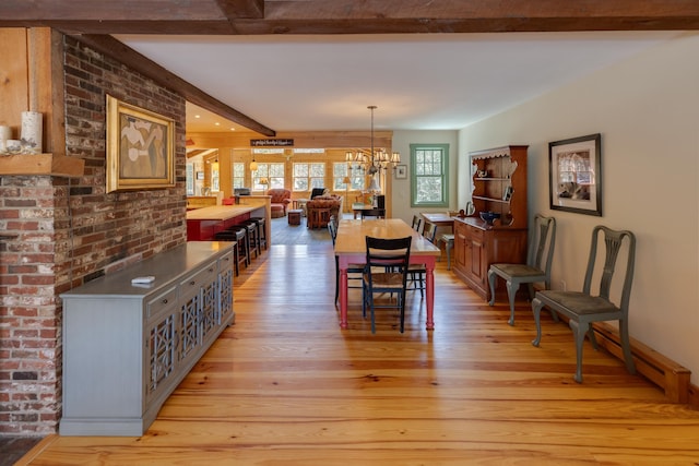 406 Partridge Lake Rd, Littleton, NH 03561 - dining space with beamed ceiling, light wood-style flooring, and a chandelier