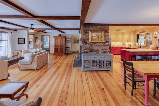 406 Partridge Lake Rd, Littleton, NH 03561 - living area with healthy amount of natural light, light wood-type flooring, beamed ceiling, and a ceiling fan