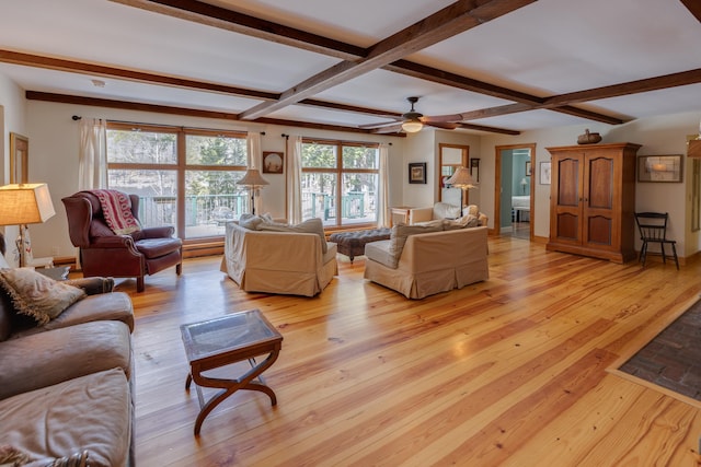 406 Partridge Lake Rd, Littleton, NH 03561 - living room with light wood finished floors, beam ceiling, and ceiling fan