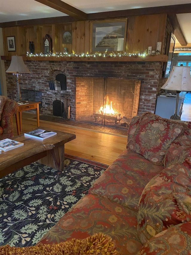 406 Partridge Lake Rd, Littleton, NH 03561 - living room with a warm lit fireplace, wood finished floors, and wooden walls
