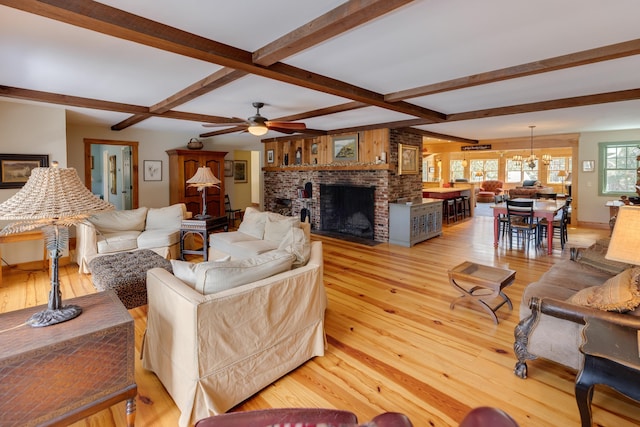 406 Partridge Lake Rd, Littleton, NH 03561 - living area featuring a fireplace, beam ceiling, light wood-style flooring, and ceiling fan