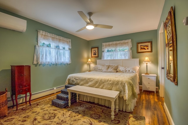 406 Partridge Lake Rd, Littleton, NH 03561 - bedroom with a baseboard heating unit, a wall mounted air conditioner, wood finished floors, ceiling fan, and baseboards